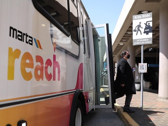 Rider disembarking MARTA Reach vehicle